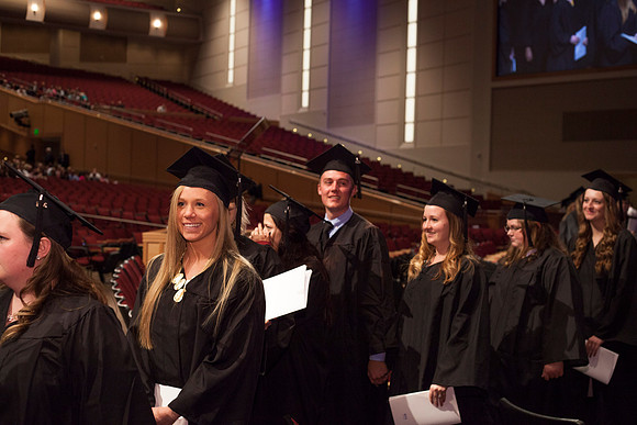Graduates leave the BYU-Idaho Center in search for family members, after the Commencement Ceremony.