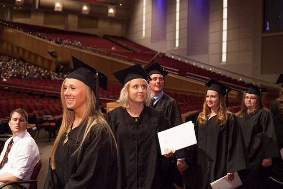 Graduates leave the BYU-Idaho Center in search for family members, after the Commencement Ceremony.