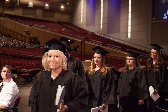 Graduates leave the BYU-Idaho Center in search for family members, after the Commencement Ceremony.