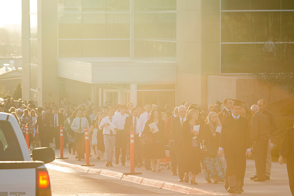 Graduates leave the BYU-Idaho Center in search for family members, after the Commencement Ceremony.