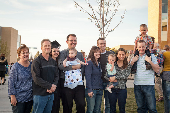 A graduate celebrates with her family after the April Commencement Ceremony.