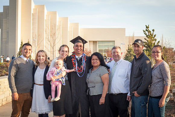 A graduate celebrates with his family after the April Commencement Ceremony.