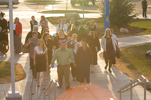 Graduates walk with family and friends towards the Taylor Building after the Commencement Ceremony.