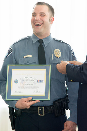 Garth Gunderson, University Security and Safety Director present a pin representing his award to Bryan Lyons.