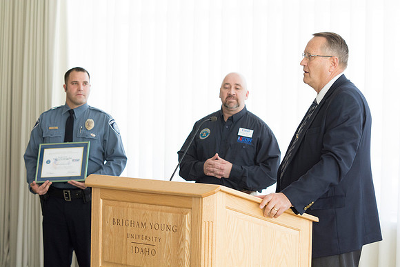 Garth Gunderson, University Security and Safety Director signs a contract from ESGR explaining his commitment to continue to help Students in the Guard and Reserves.