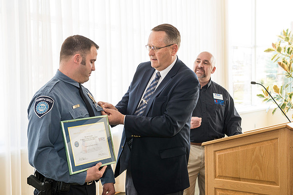 George Hames, Public Affairs Director for ESGR (Employer Support of The Guard and Reserve) and Garth Gunderson present an award to Bryan Lyons.
