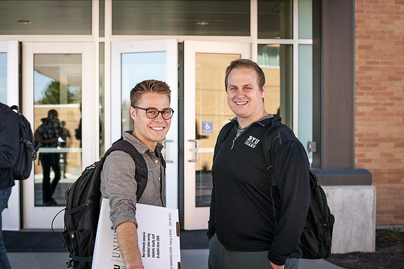 Students smile outside the Manwaring Center on the first day of school during the Spring Semester.