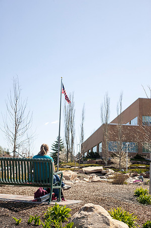 A student looks over her class schedule outside in the Taylor Quad.