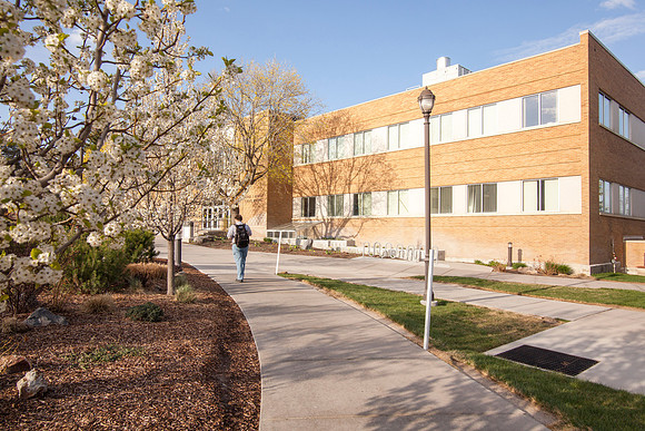 A student walks towards the Romney Building on the second day of the Spring 2015 Semester.