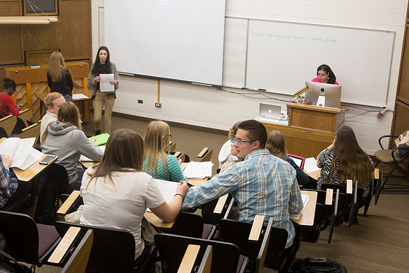 Studens settle down before class begins.