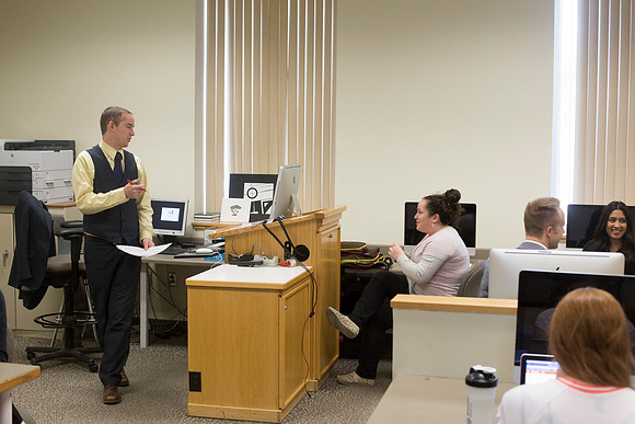 Brother Eric Lybbert speaks with a student before class begins.