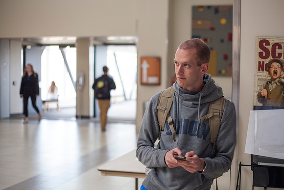 Garrett Cardinet, a Cadet in the BYU-Idaho Army ROTC, sends a text message to a friend during finals week in the Manwaring Center.