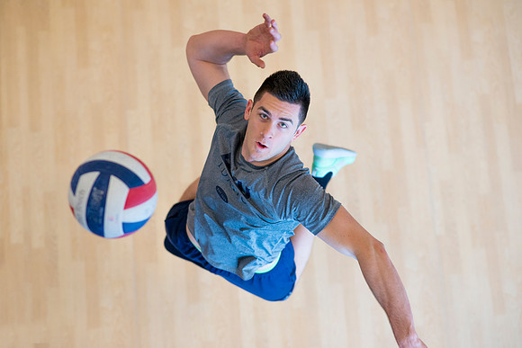 Cameron Olsen spikes the ball during his volleyball class in the I-Center.
