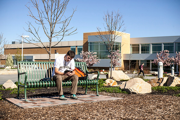A student studies his scriptures in the Taylor Quad during the 2015 Spring Semester.