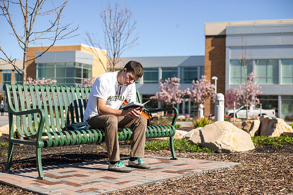 A student studies his scriptures in the Taylor Quad during the 2015 Spring Semester.