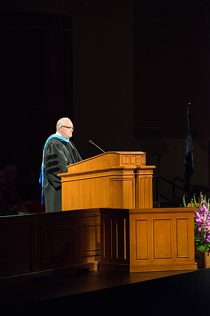 Paul V Johnson, of the board of educations speaks at the commencement ceremony. Photo by Ryan Chase