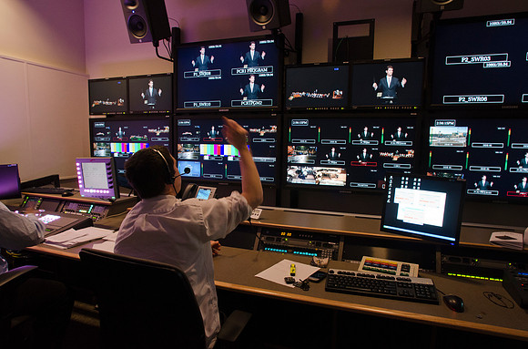 Mike Jeffs the Video Production Coordinator runs the show behind the scenes for Devotional  in AV Main Control Room.