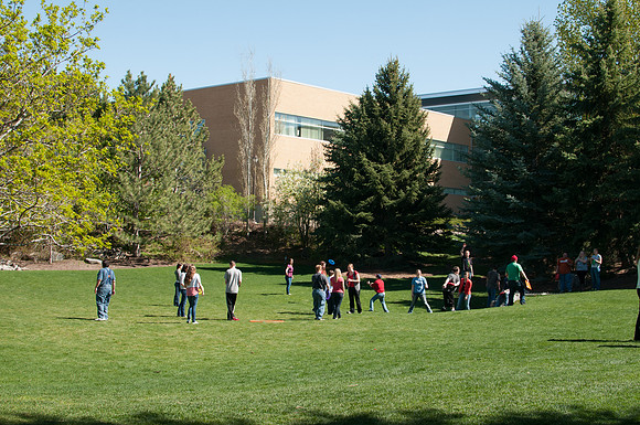 Students play frisbee with those who have disabilities in the Thomas E. Ricks Garden.