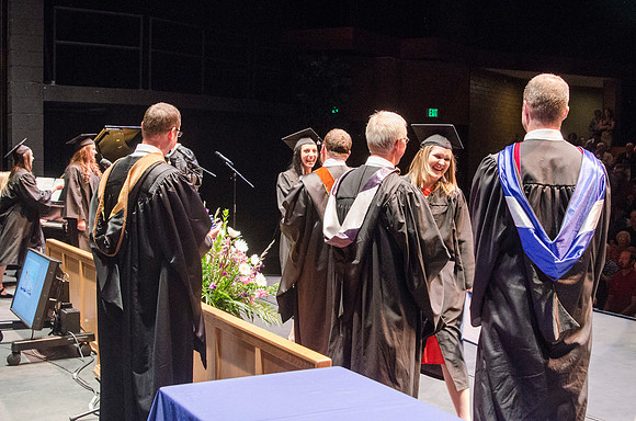 Dean's of the College of Performing and Visual Arts award diplomas to graduates during convocation held in the Snow Building. Photo by Tyler Rickenbach