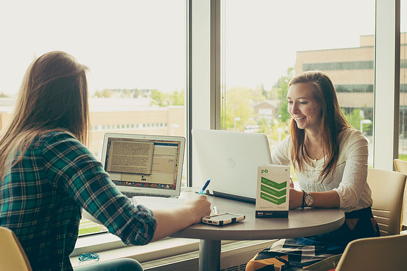 Faith Brown and Chelsey Fjeldsted study in the Manwaring Center.