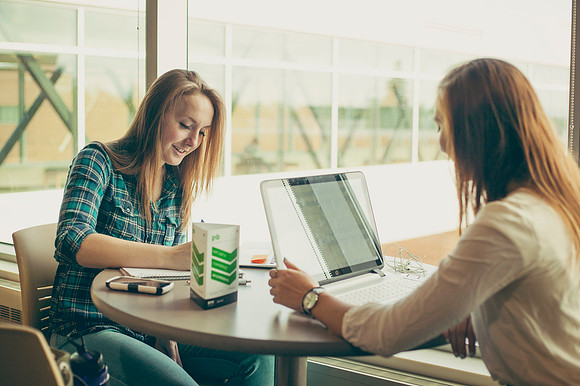 Faith Brown and Chelsey Fjeldsted study in the Manwaring Center.