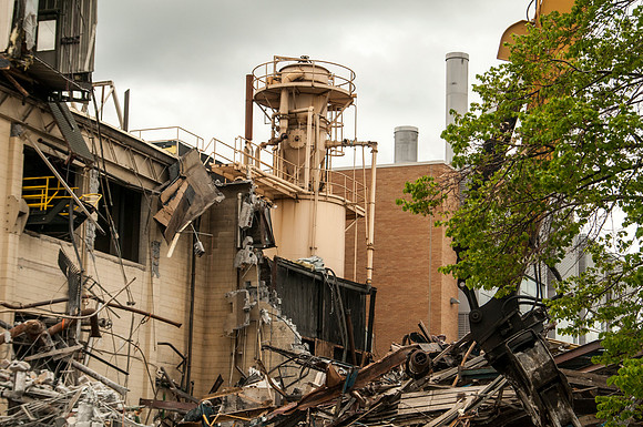 A construction crew continues to tear down the old heating plant.