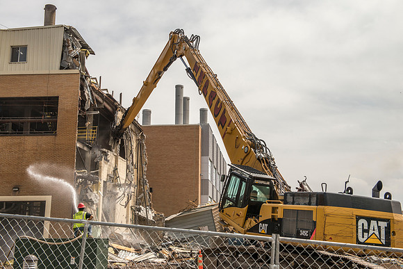 A construction crew continues to tear down the old heating plant.
