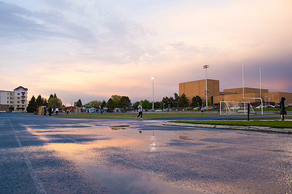 The sun sets beautifully after some rain during a soccer game at the BYU-Idaho Stadium.