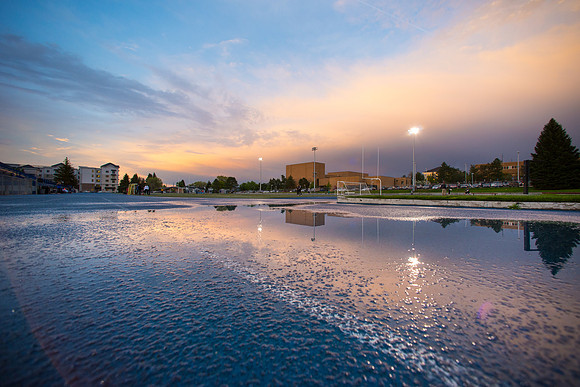 The sun sets beautifully after some rain during a soccer game at the BYU-Idaho Stadium.