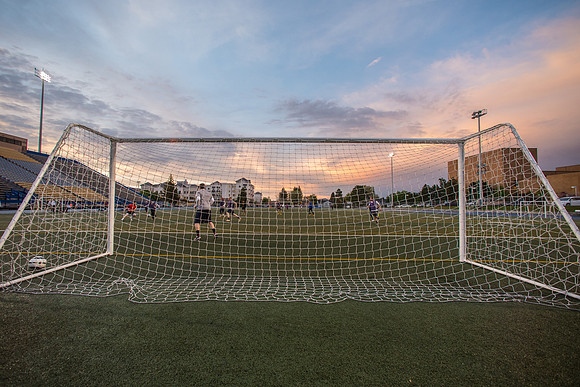 The sun sets beautifully after some rain during a soccer game at the BYU-Idaho Stadium.