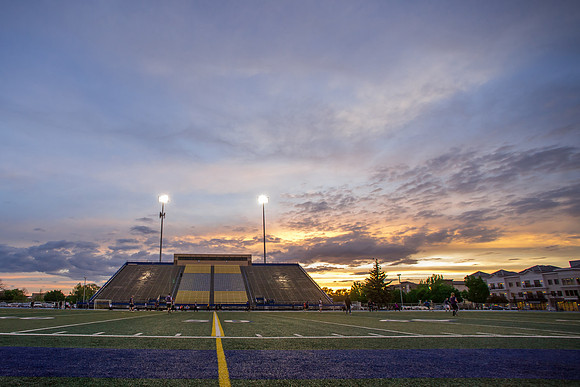 The sun sets beautifully after some rain during a soccer game at the BYU-Idaho Stadium.