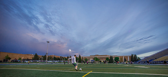 The sun sets beautifully after some rain during a soccer game at the BYU-Idaho Stadium.