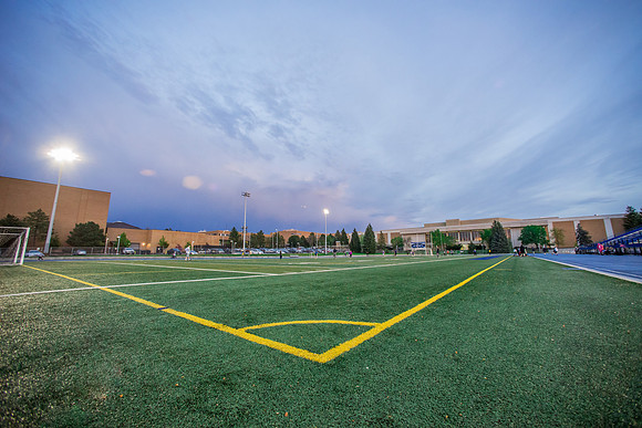 The sun sets beautifully after some rain during a soccer game at the BYU-Idaho Stadium.