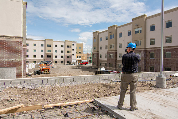 Mike Lewis takes a picture from the courtyard of the new dorms.