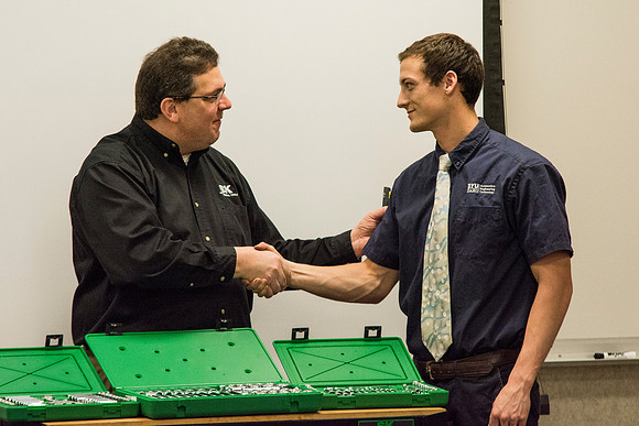 Rob Conrad formally congratulates Beau Calderwood while awarding him the Grand Prize.