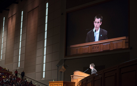 A student is asked to share a scripture each week at the start of devotional in the BYU-Idaho Center.