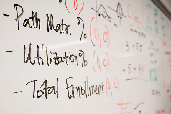 Employees work on developing a better curriculum for online students.