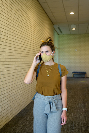 Student volunteers show the way to stay safe during this COVID 19 pandemic by social distancing, following pathway arrows and proper wearing of masks .