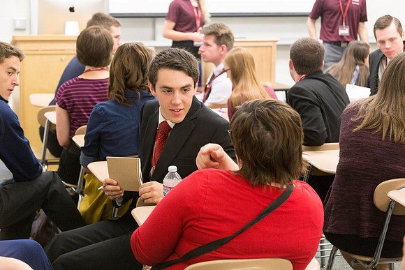 Student Jason Newquist discusses what he learned with a fellow conference member during a breakout session. '