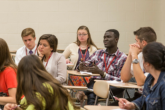 Students discuss what they learned during the first session together during a "breakout".