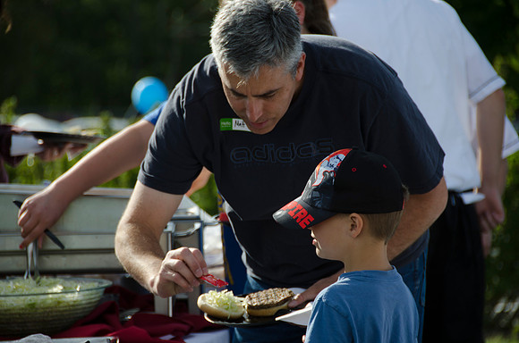 Online instructors gather with their families for an eveing of BBQ and games.