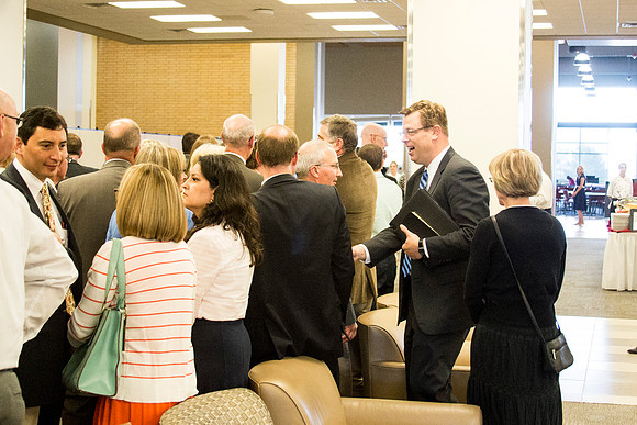 President Gilbert speaks with BYU-Idaho faculty before the banquet.