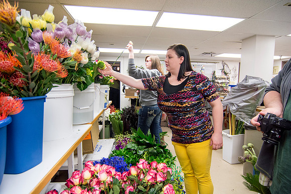 Horticulture students prepare for a semester review fashion show that will show their floral designs as well. Brother Romney leads the students along with other instructors.