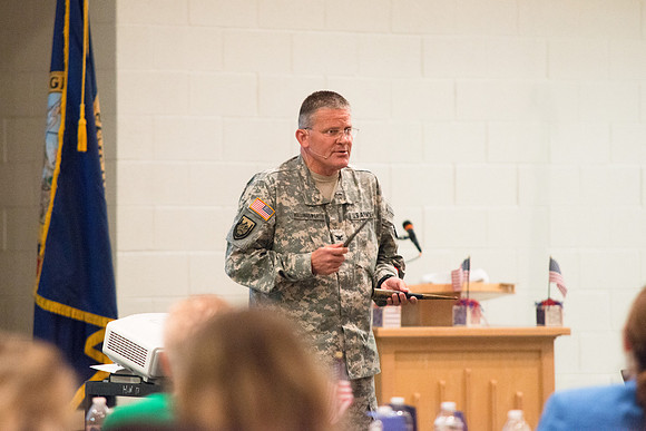 Colonel Guy Hollingworth speaks at the University Women's Assocation Luncheon.