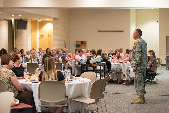 Colonel Guy Hollingworth speaks at the University Women's Assocation Luncheon.