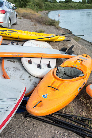 Students of Brigham Young University-Idaho go standup paddle boarding on the river at Warm Slough.