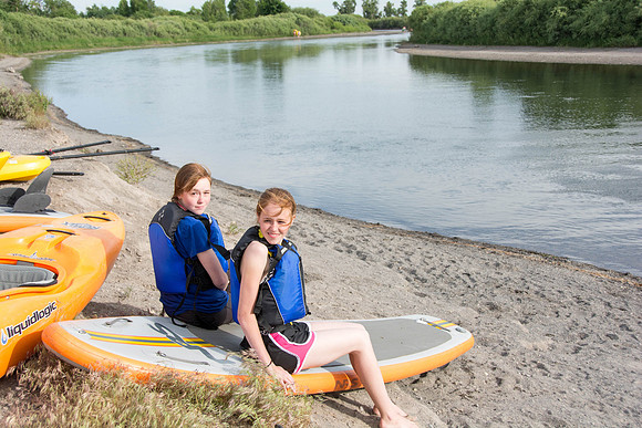 Students of Brigham Young University-Idaho go standup paddle boarding on the river at Warm Slough.