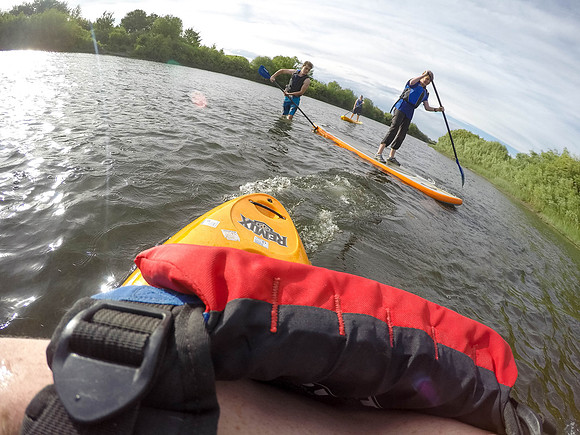Students of Brigham Young University-Idaho go standup paddle boarding on the river at Warm Slough.