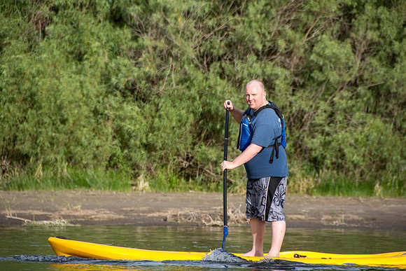 Students of Brigham Young University-Idaho go standup paddle boarding on the river at Warm Slough.