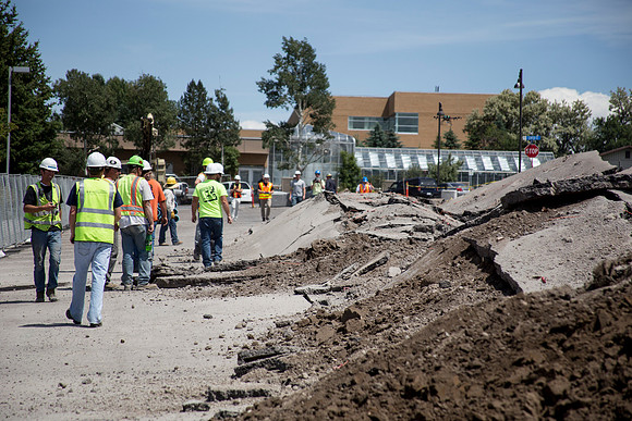Workers survey the blast site.